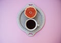 A cup of coffee on and a half of grapefruit on silver tray. Royalty Free Stock Photo