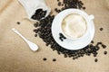 Cup of fresh coffee with coffee beans on burlap warm cup on brown background top view Royalty Free Stock Photo