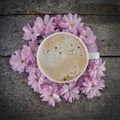 A cup of fresh coffee on a bunch of flowers Royalty Free Stock Photo