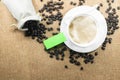 Cup of fresh coffee with coffee beans on burlap warm cup on brown background top view Royalty Free Stock Photo