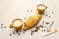 A cup of fresh coffee with croissant. Stone background Royalty Free Stock Photo