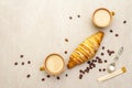 A cup of fresh coffee with croissant. Stone background Royalty Free Stock Photo