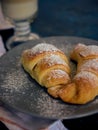 A cup of fresh coffee with croissants on a dark blue background, selective focus Royalty Free Stock Photo