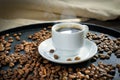 Cup of fresh coffee and roasted coffee beans, closeup. Background, texture, good morning concept Royalty Free Stock Photo