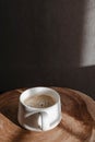 Cup of fresh espresso on a small wooden table, morning coffee Royalty Free Stock Photo