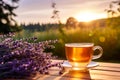 Cup of fresh healthy lavender tea on a wooden table on sunny morning. Lavender tea poured into clear glass cup. Herbal medicine