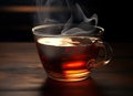 A Cup of freshly brewed black tea,escaping steam,warm soft light, darker background. Created with Generative AI