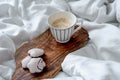 Cup of freshly brewed coffee and gingerbread cookies on the bed. Cozy morning at home