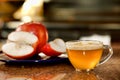 Cup of freshly juiced apple on kitchen counter next to plate of raw apples Royalty Free Stock Photo