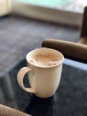 Cup of frothed hot drink Royalty Free Stock Photo