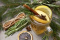 Cup fruit tea with Apple and lemon, cinnamon, star anise,  rosemary, Lollipop, fir branches on a gray background Royalty Free Stock Photo