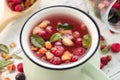 Cup of fruit tea with apples, orange, red and black currant berries Royalty Free Stock Photo