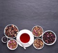 Cup of fruit tea on dark, stone background, top view