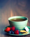 Cup of fruit tea with strawberries, raspberries and blueberries on wooden table, with copy space. Royalty Free Stock Photo