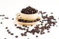 Cup full of coffee beans on on white background Royalty Free Stock Photo
