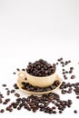 Cup full of coffee beans on on white background Royalty Free Stock Photo