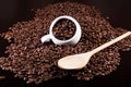 Cup full of coffee beans and a wooden spoon Royalty Free Stock Photo