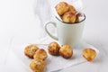 Cup full of fried sweet cheese balls on the baking paper.Sweet delicious snack