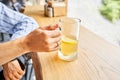 Cup of ginger root tea with lemon, honey and mint on a wooden table and High-mountain river in the background. Walk in Royalty Free Stock Photo