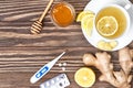 Cup of ginger tea, honey, lemon, pills, thermometer. Healthy con Royalty Free Stock Photo