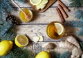 Cup of ginger tea with honey and lemon on wooden table. Healthy drink. Hot winter Christmas beverage concept.