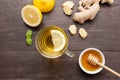 Cup of ginger tea with lemon, ginger, honey on wooden background Royalty Free Stock Photo