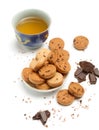 Cup of green chinese tea, tasty biscuit cookies and dark chocolate pieces and chips lie isolated on white background Royalty Free Stock Photo