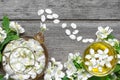 Cup of green herbal tea with jasmine flowers and teapot over rustic wooden background Royalty Free Stock Photo