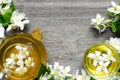 Cup of green herbal tea with jasmine flowers and teapot Royalty Free Stock Photo