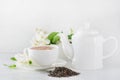 Cup of green jasmin tea white jasmine flowers, teapot. Teatime.