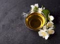 Cup of green tea and Jasmine flowers on a black background. Herbal medicine Royalty Free Stock Photo