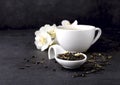 Cup of green tea and Jasmine flowers on a black background. Herbal medicine Royalty Free Stock Photo