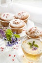 Cup of green tea with lemon balm and tasty muffins with sugar hearts Royalty Free Stock Photo