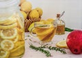 Cup of green tea with lemon.Cut lemons with sugar in jar,fresh full lemons on background. Red peach on the table Royalty Free Stock Photo
