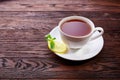 Cup with green tea and teapot on wooden background Royalty Free Stock Photo