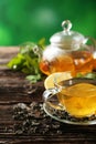 Cup with green tea and teapot on a brown wooden background Royalty Free Stock Photo