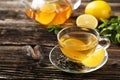 Cup with green tea and teapot on the brown wooden background Royalty Free Stock Photo