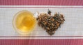 Cup of healing tea and dry Sagan daila tea leaves in shape heart. medicinal herb sagan daila for healing tea , Rhododendron of