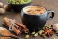 Cup of ayurvedic masala tea or coffee, hot chocolate with aromatic spices. Cinnamon sticks, cardamom, allspices and anise Royalty Free Stock Photo