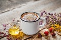 Cup of healthy daisy tea, honey and healing herbs on table. Royalty Free Stock Photo