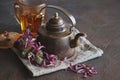 Cup of healthy echinacea tea, dry coneflower herbs and retro teapot