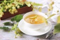 Cup of herbal linden tea with linden flowers Royalty Free Stock Photo