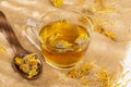 A cup of herbal medicinal tea dried calendula and marigold flowers Royalty Free Stock Photo