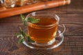 Cup of herbal mint tea with dry herbs on the tray. Royalty Free Stock Photo