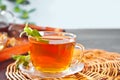 Cup of herbal mint tea with dry herbs on the tray. Royalty Free Stock Photo