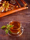 Cup of herbal mint tea with dry herbs on the tray. Royalty Free Stock Photo