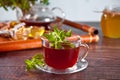 Cup of herbal mint tea with dry herbs on the tray. Royalty Free Stock Photo