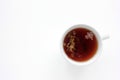 Cup of herbal oregano tea with dry marjoram flowers on white table background with copy space.