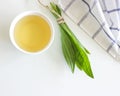 A cup of herbal tea against cough with fresh ribwort plantain leaves.Hebal medicine. Minimalism. Beautiful spring Royalty Free Stock Photo