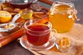 Cup of herbal tea with flowers, honey in jar, teapot and and various dried herbs on the tray. Royalty Free Stock Photo